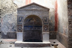 <b>A richly decorated fountain in a home of Pompeii ruins</b>